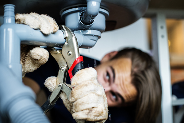 Man fixing kitchen sink